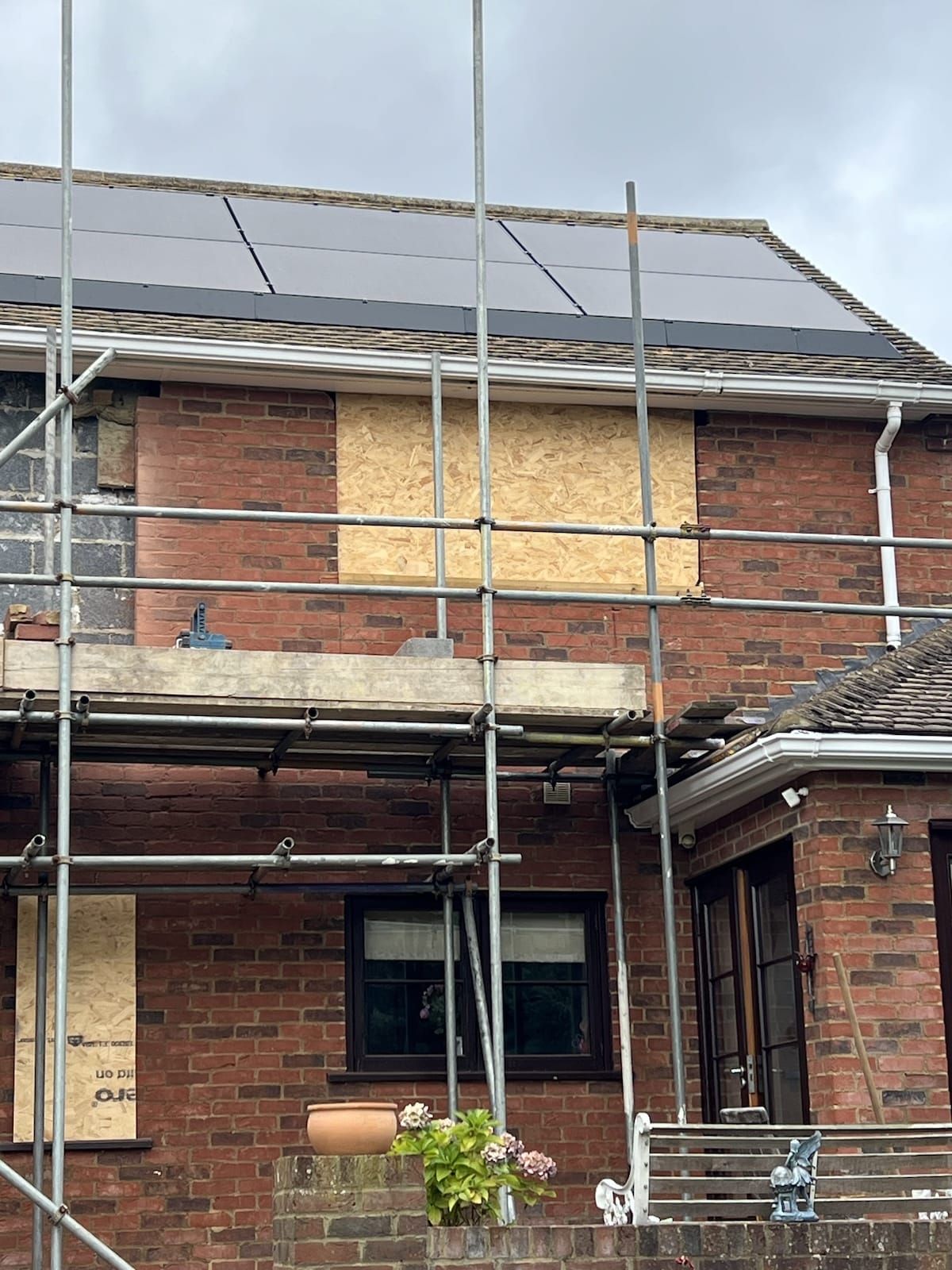 A man on a roof fitting solar panels